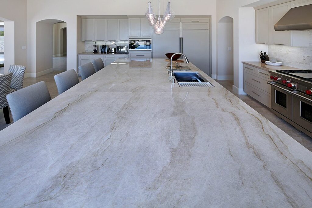 large kitchen island with quartzite slab countertops